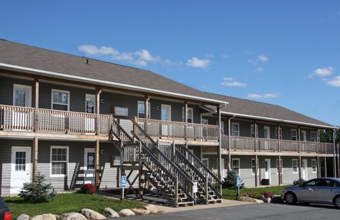 A building with a wooden staircase leading to the second floor.
