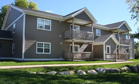 A two-story house with a balcony on the second floor.