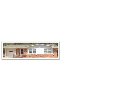 A house with a red brick wall and a white door.