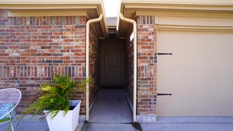A white door is at the end of a hallway.