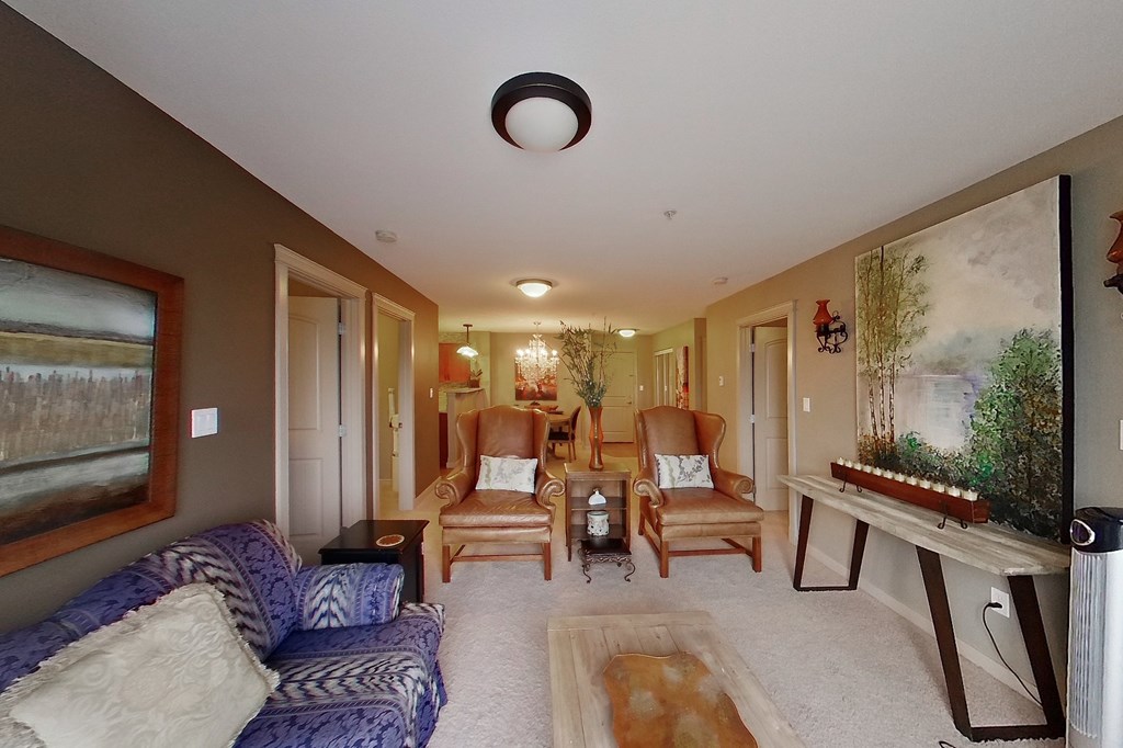 A living room with a blue sofa and a wooden coffee table.