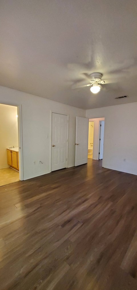 A room with wooden floors and white walls.