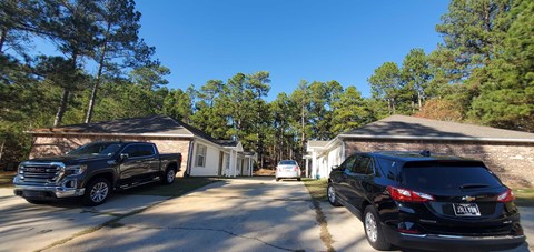 A black SUV is parked in front of a house.