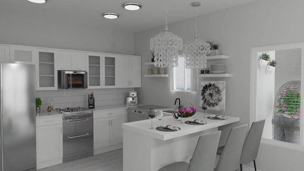 A modern kitchen with a dining table set for two.