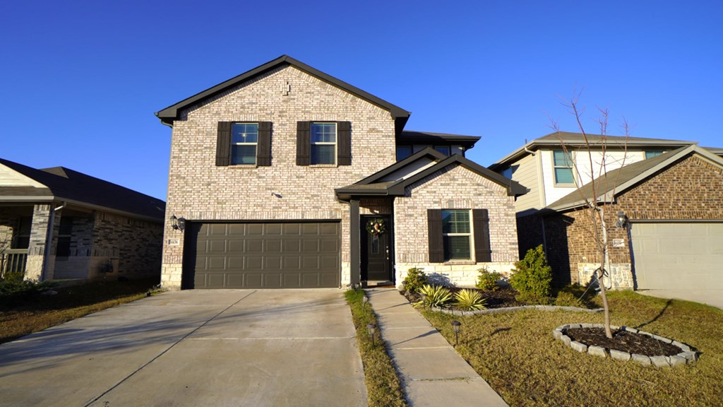A house with a garage and a driveway.