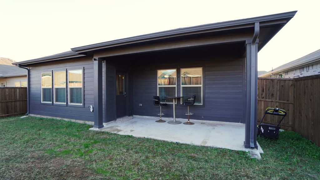 A house with a grey roof and a blue exterior.