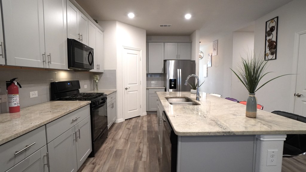A kitchen with a countertop and a sink.