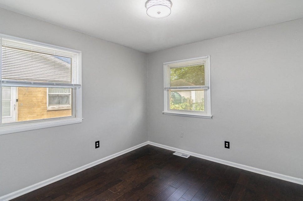 A room with a window and a door visible through the window.