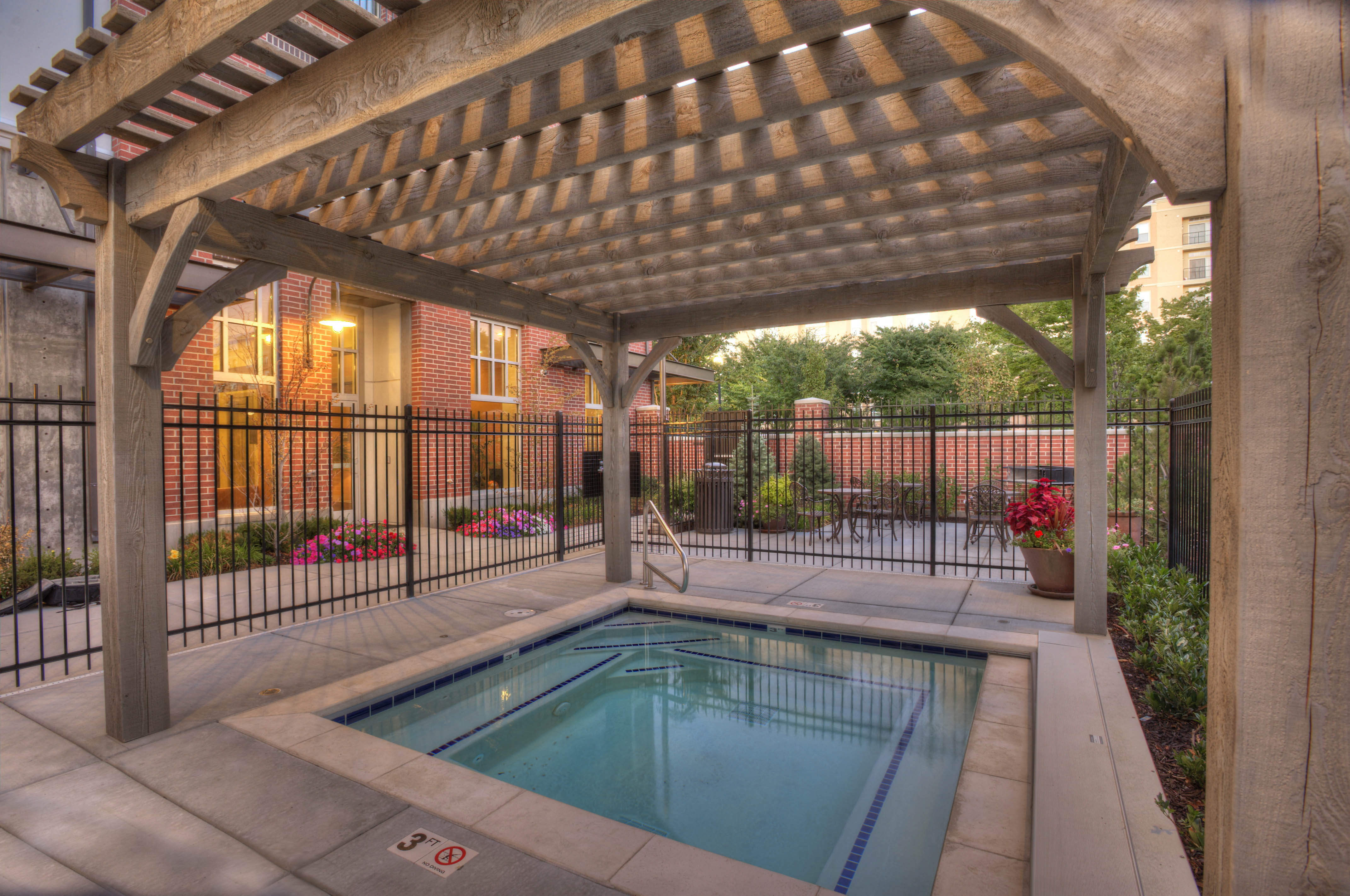 a swimming pool is under a covered patio with a pergola