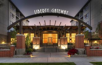 the entrance to the liberty gateway building at night