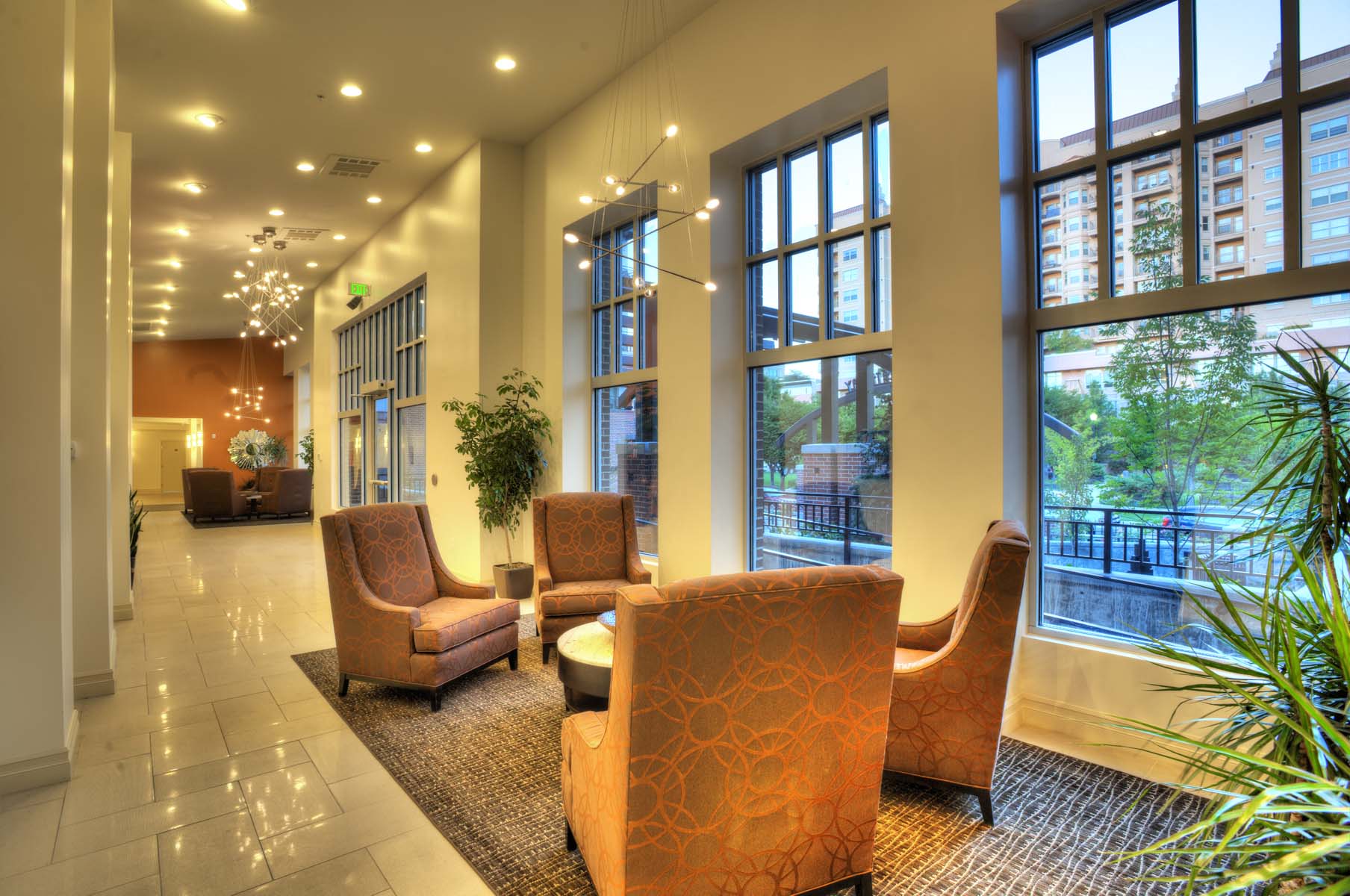a lobby with chairs and large windows