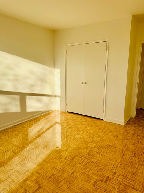 A room with a wooden floor and a white door.