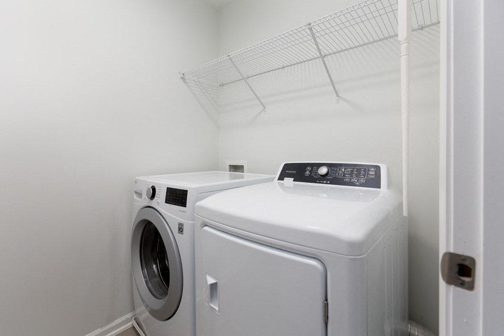 A washing machine and dryer in a small laundry room.