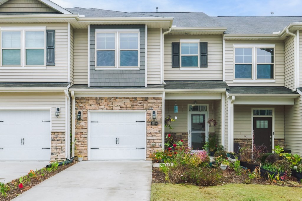A two-story house with a garage on the first floor.