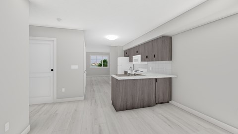 A modern kitchen with a white door and a window.