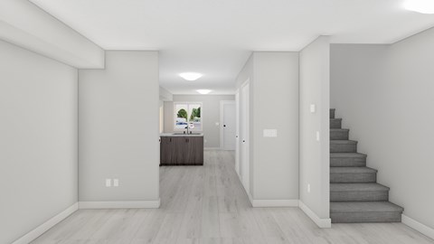 A spacious hallway with a staircase leading to the second floor.