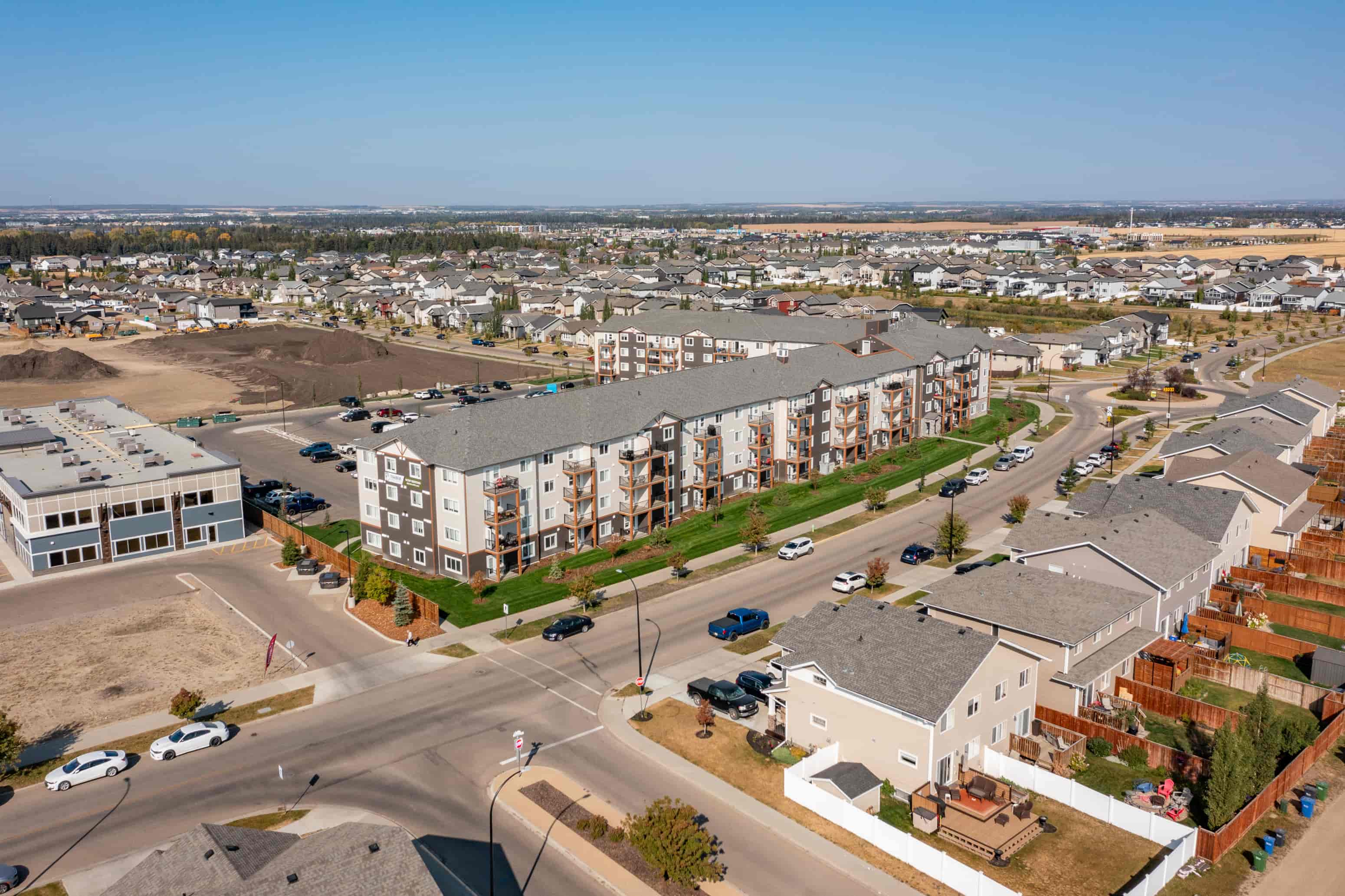 A large apartment complex is under construction in a suburban area.