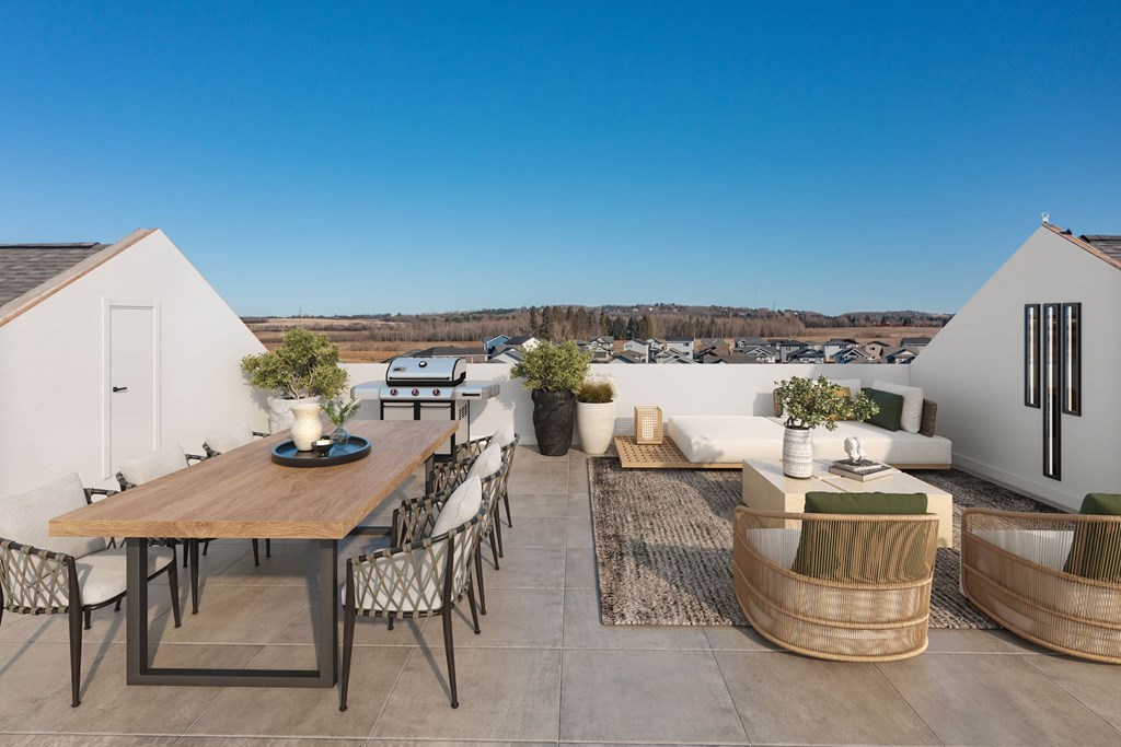 A modern outdoor dining area with a wooden table and chairs.
