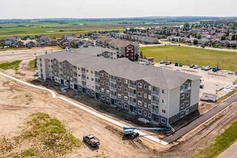 A large building with a parking lot in front of it.