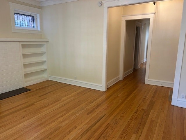 A room with wooden floors and a window.
