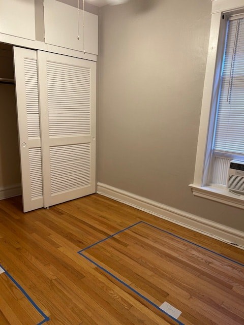 A room with a wooden floor and a white closet.