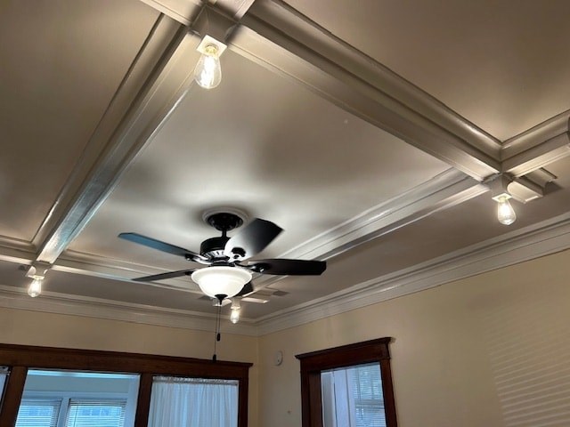 A ceiling fan with lights is installed in a room with a window.