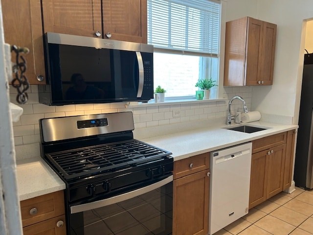 A kitchen with a black stove top oven and a black microwave.