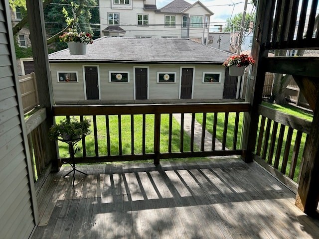 A balcony with a chair and a view of a house.