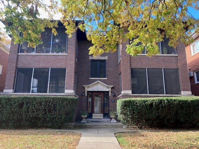 A red brick building with a black door and windows.