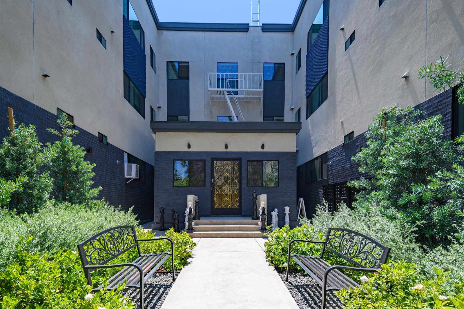 A modern building with a glass door and a balcony.