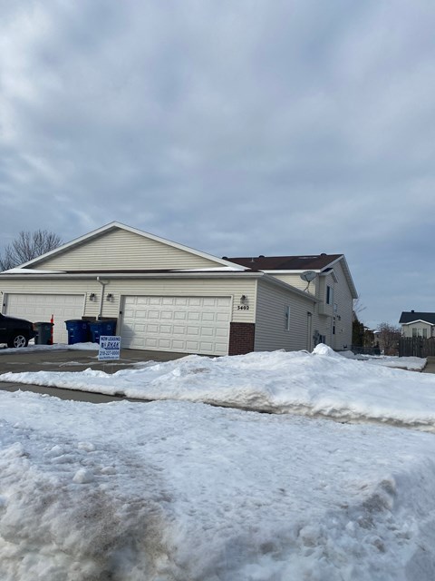 A house with a garage is for sale.