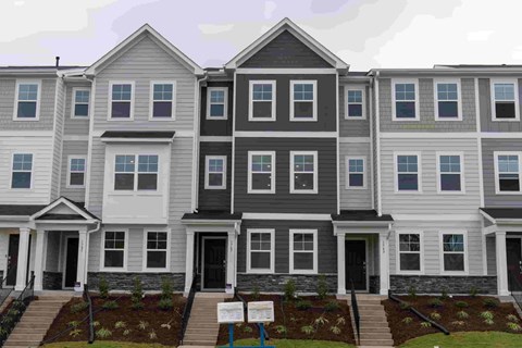 A row of townhouses with grey and white exteriors.