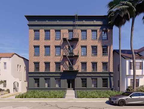 A modern building with a car parked in front.