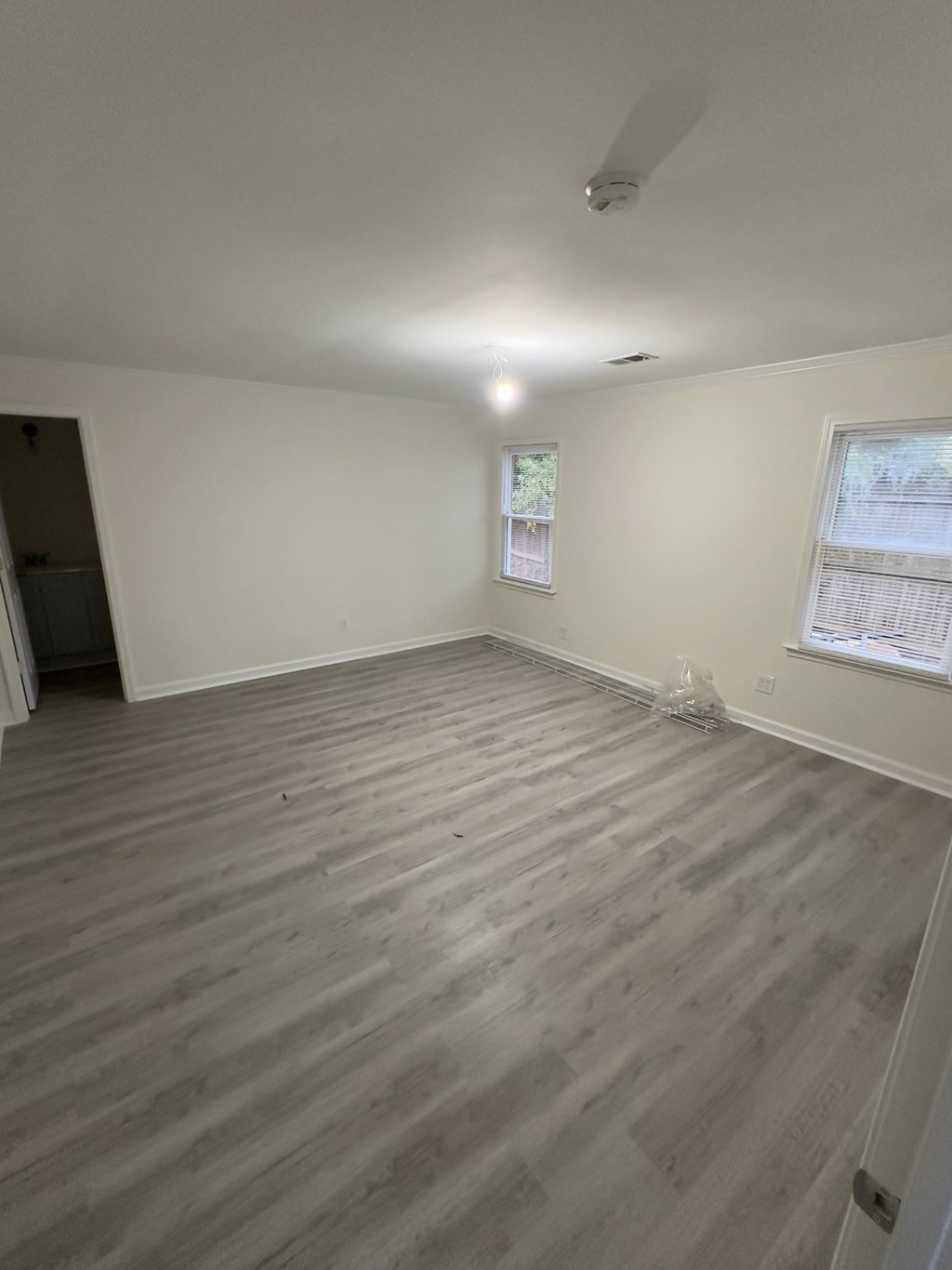 A room with a window and a door.