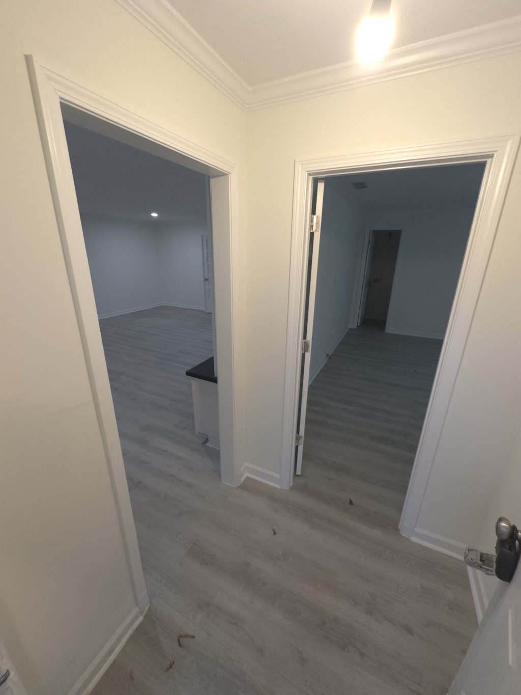 A room with a white door and a white wall.