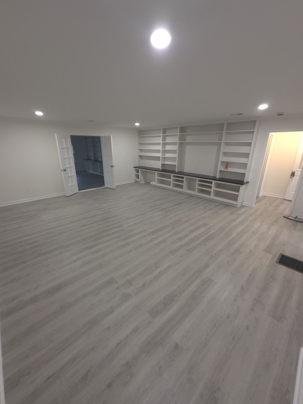A room with a grey floor and white walls.