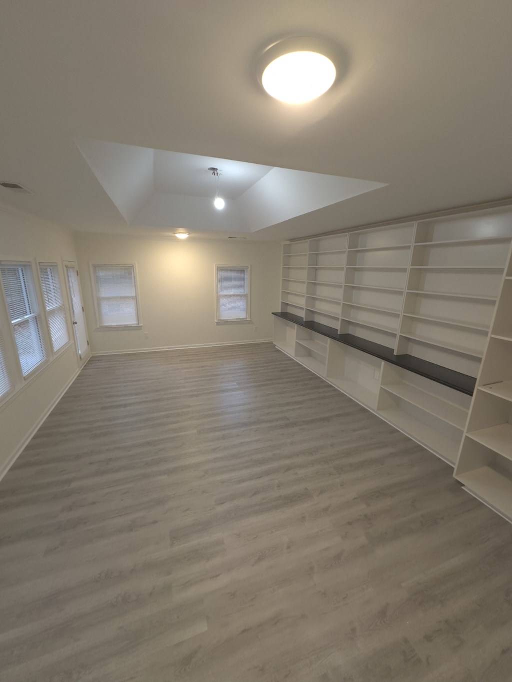 A room with wooden floors and white walls.