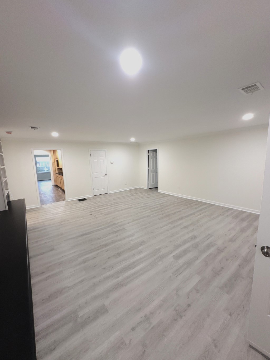 A room with a wooden floor and white walls.