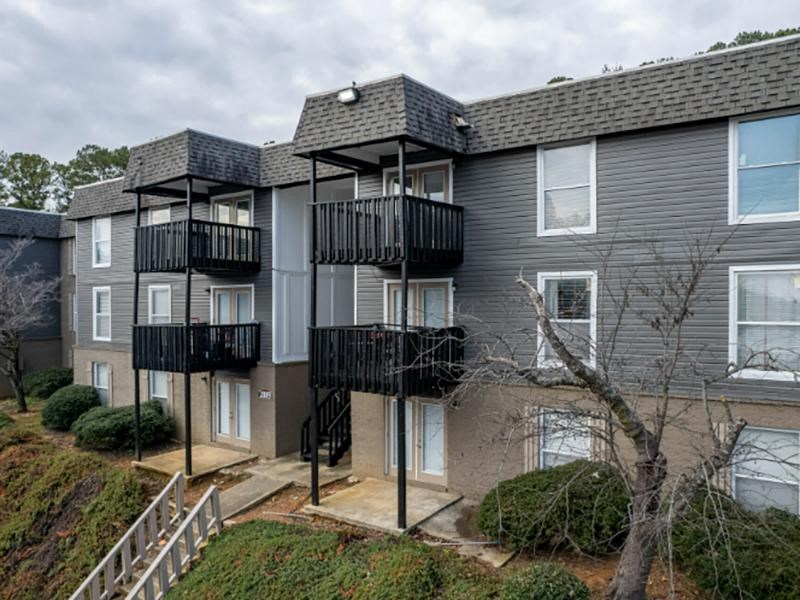 Apartment building with a black balcony railing.