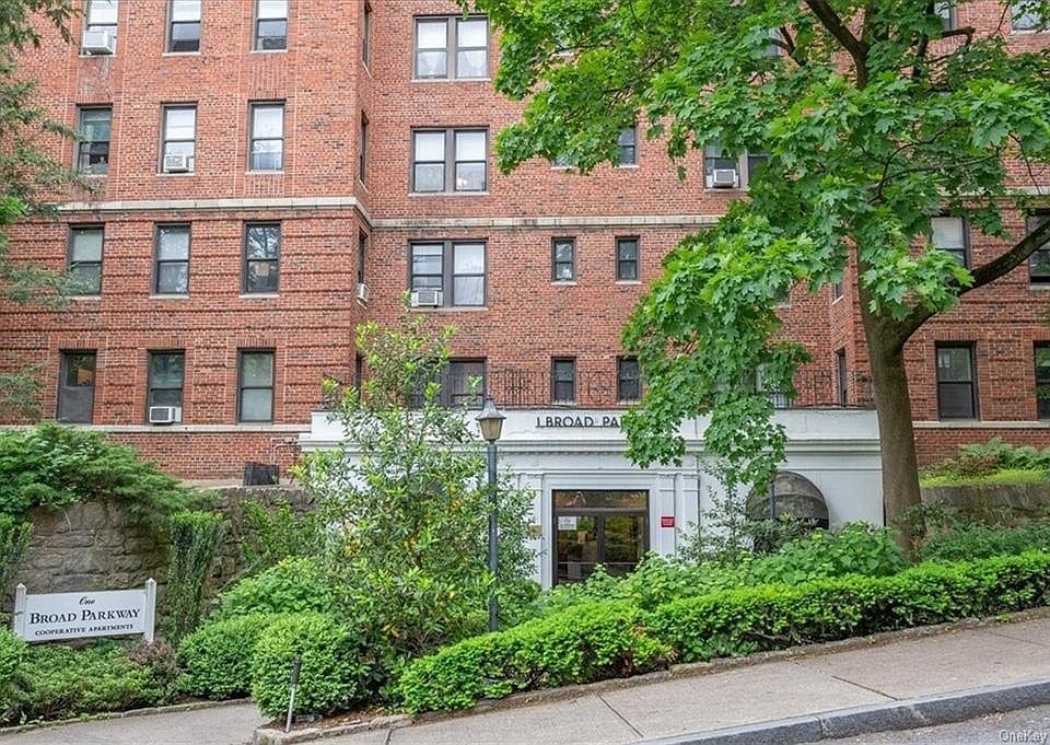 A red brick building with a white entrance and a sign that says Broad Street.