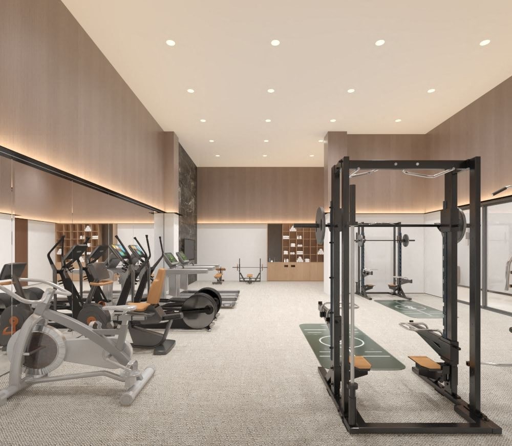 A gym with a variety of equipment including treadmills, weights, and exercise machines.