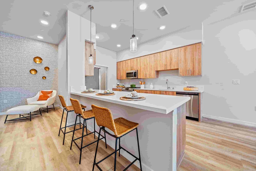A modern kitchen with a bar area and seating.