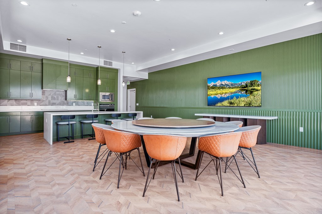 A modern dining room with a large table and chairs.
