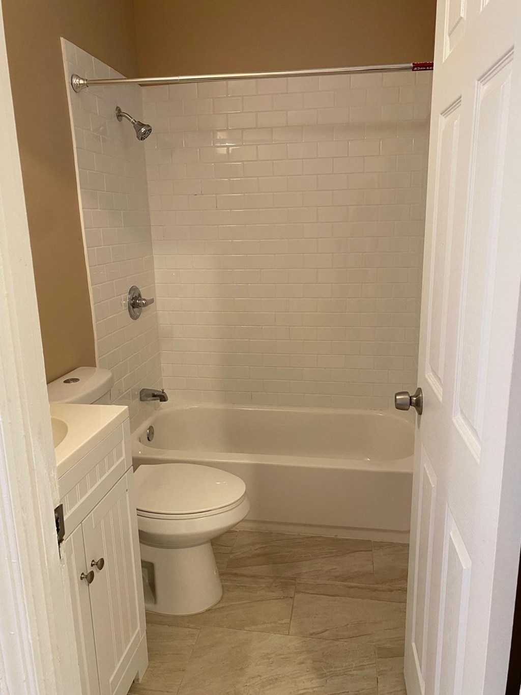 A white toilet and tub in a bathroom.