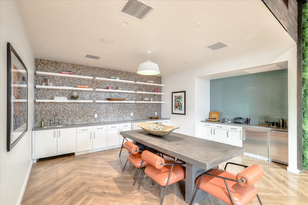 A modern kitchen with a dining table and chairs.