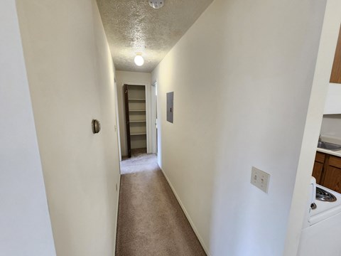 A long hallway with a door at the end.