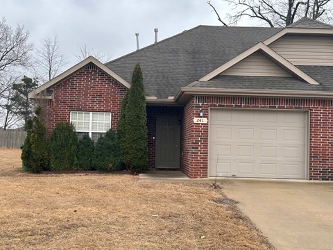 A house with a garage door numbered 241.