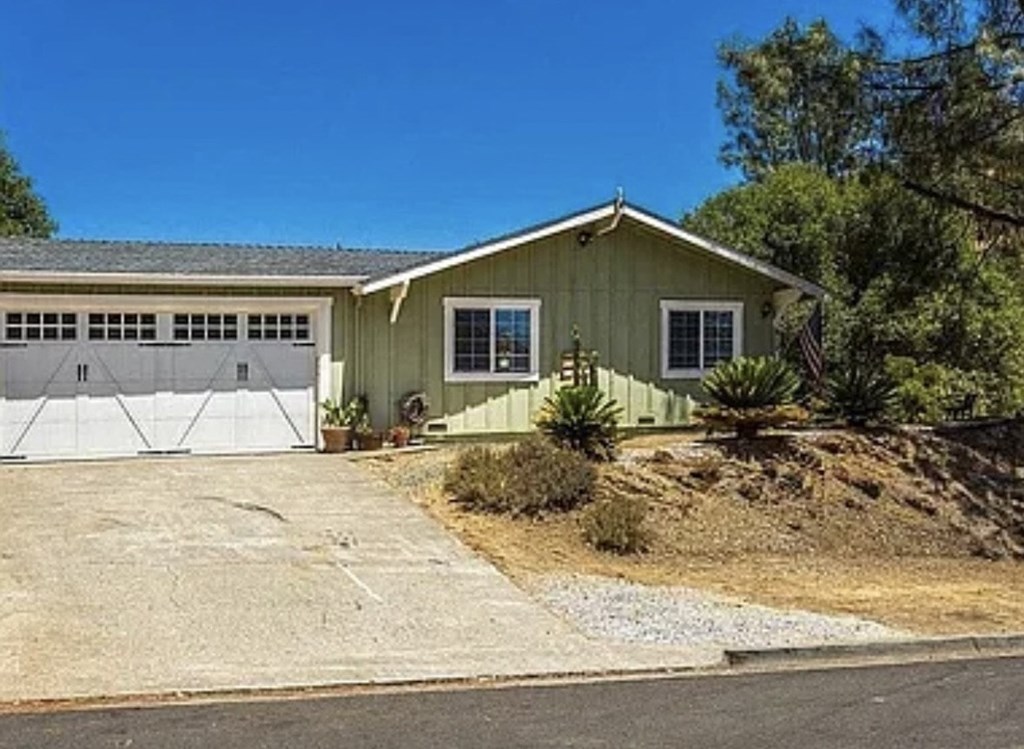 A house with a garage and a flag on the front.
