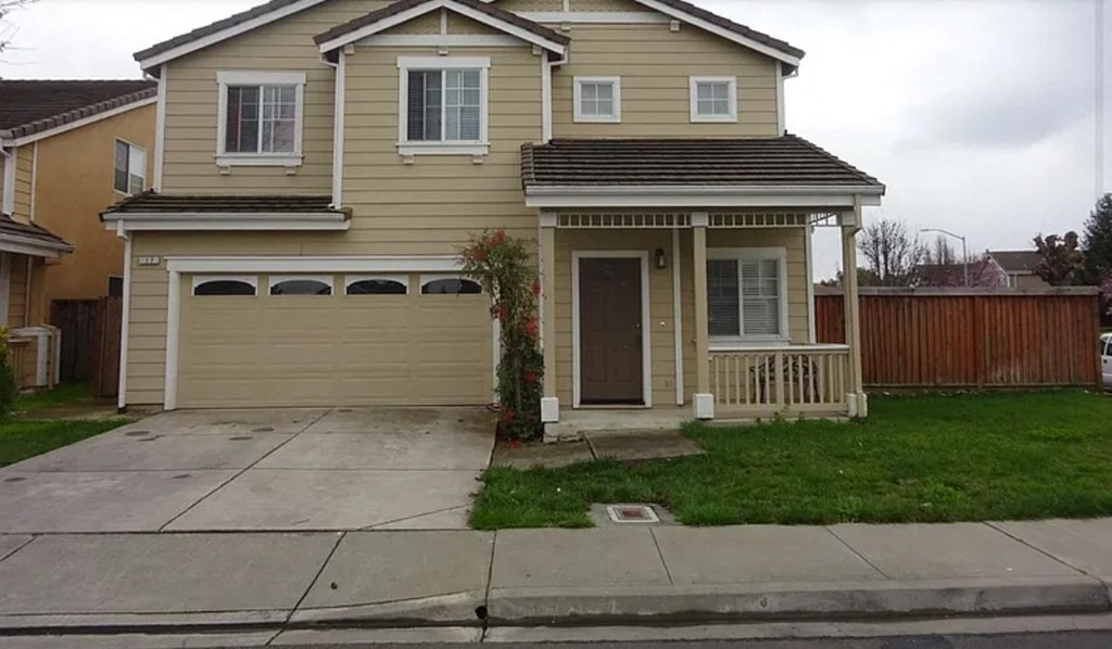 A two-story house with a garage on the first floor.