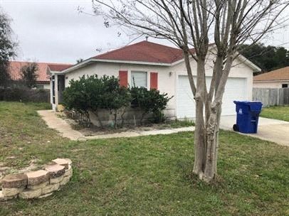 A white house with a red roof and a blue trash bin.
